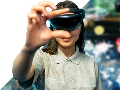 Girl wearing a virtual reality headset with hands up to the camera at NMIS