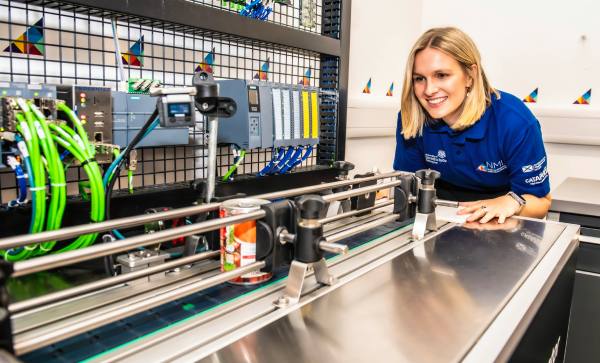 Worker looking along digital process manufacturing production line